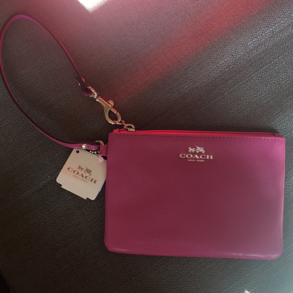 Never been used Coach small wrist pouch.